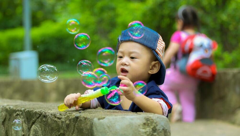 A picture of a child blowing bubbles